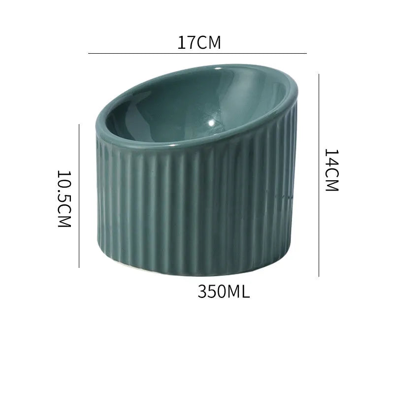 Ceramic elevated cat bowl in green, showing tilted round dish on a raised stand.