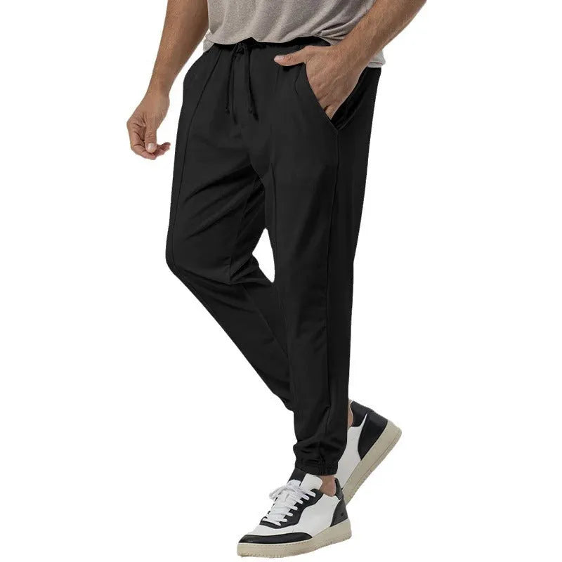 Men's gray elastic track sweatpants with straight-leg tapered design and mid waist