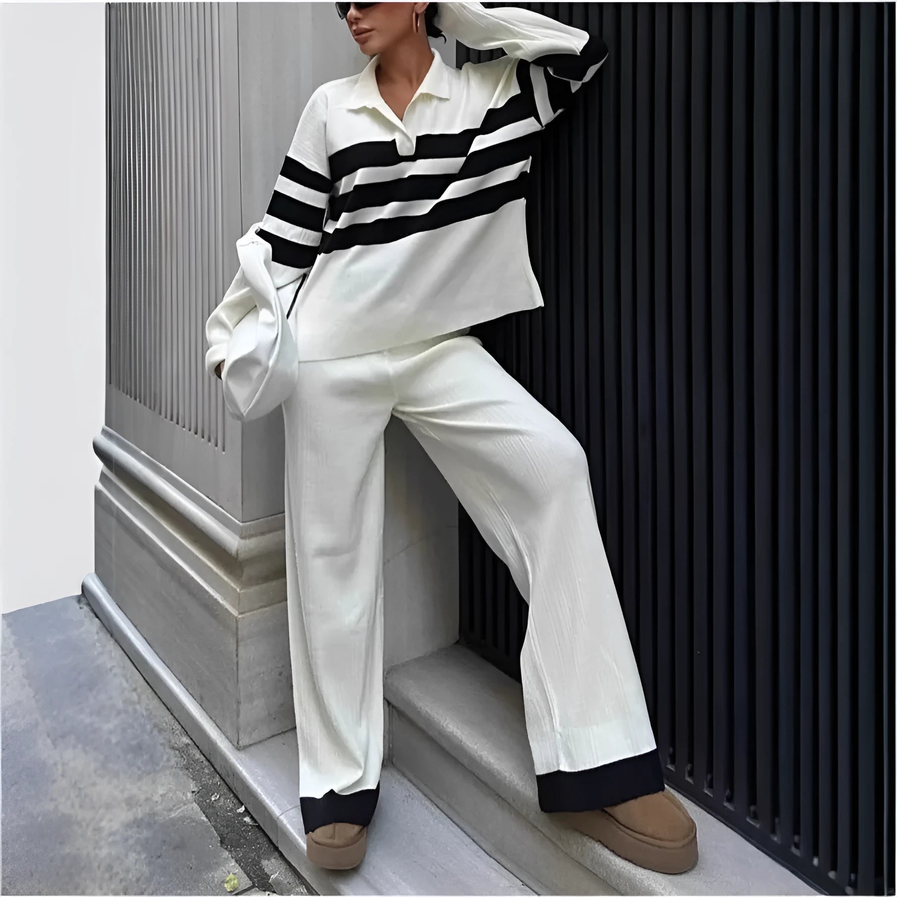 Women's black and white striped knitted two-piece set with polo collar and matching trousers