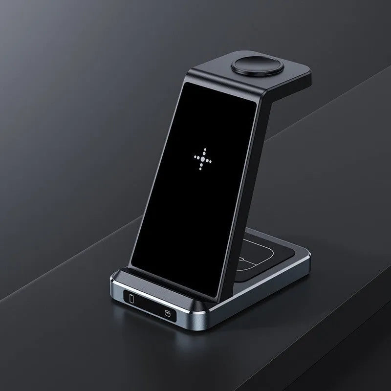 Three-in-one wireless charger in black with phone, watch, and earbuds placed on charging zones