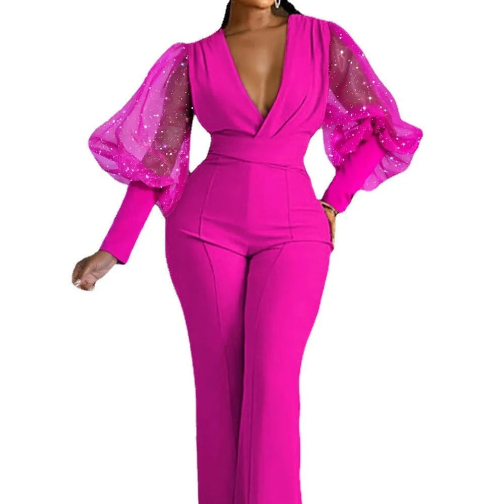Red women's jumpsuit with mesh stitching on long sleeves, slim bodice, wide legs, and an elastic waist.