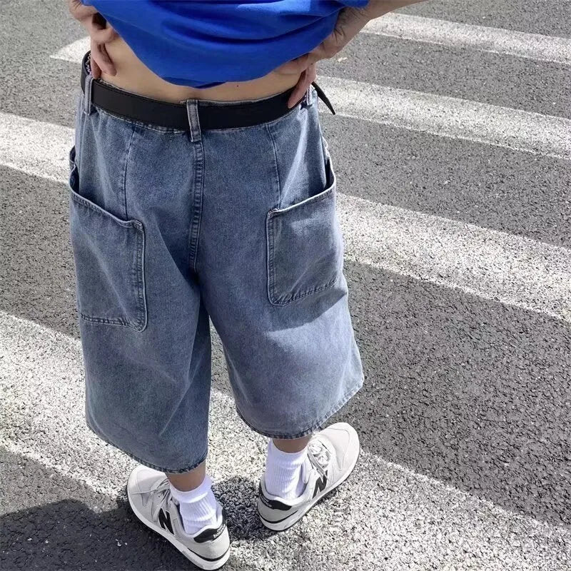 Men's washed blue denim pirate shorts with high waist and cropped length on a plain background.