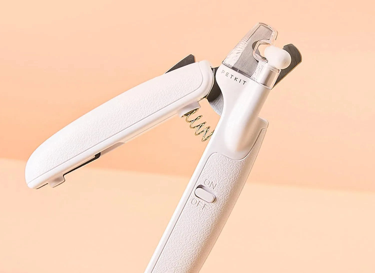 White pet nail clippers with LED light, transparent splash guard, and anti-slip handle.