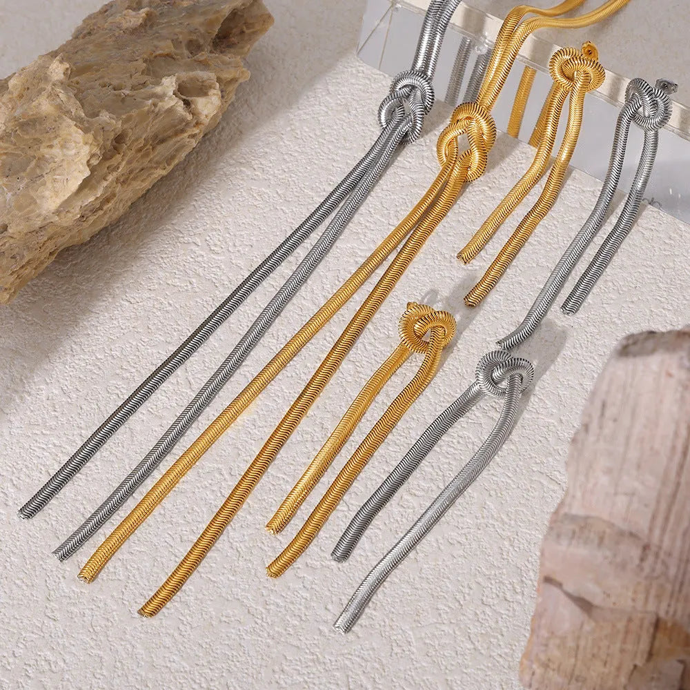 Gold colour knotted tassel pendant on a snake chain necklace with matching electroplated earrings.