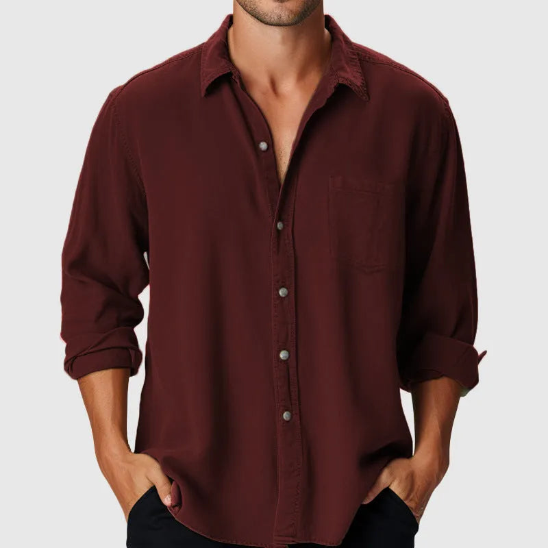 Man wearing a loose-fitting long sleeve beach shirt with a stand collar, available in various colours.