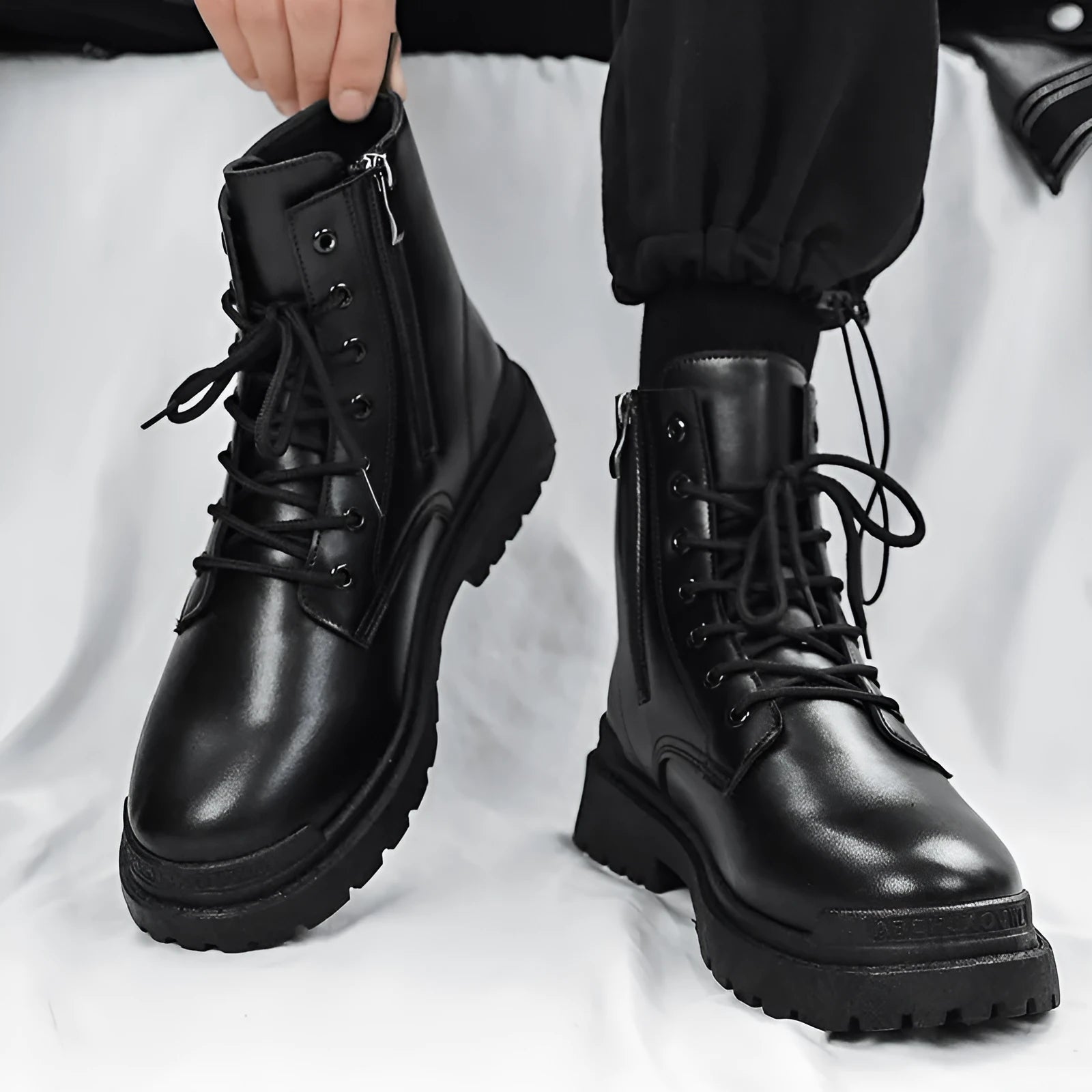 Men's black mid-top waterproof PU leather boots with a flat rubber sole.