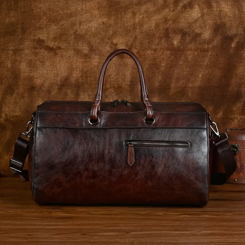 Handmade retro style leather travel bag in vintage brown colour showing expansion functionality