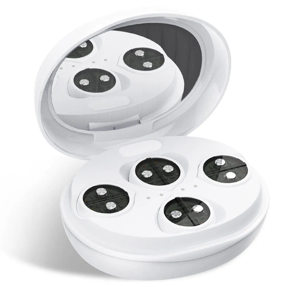 White wireless red light EMS eye and facial massager device on a table
