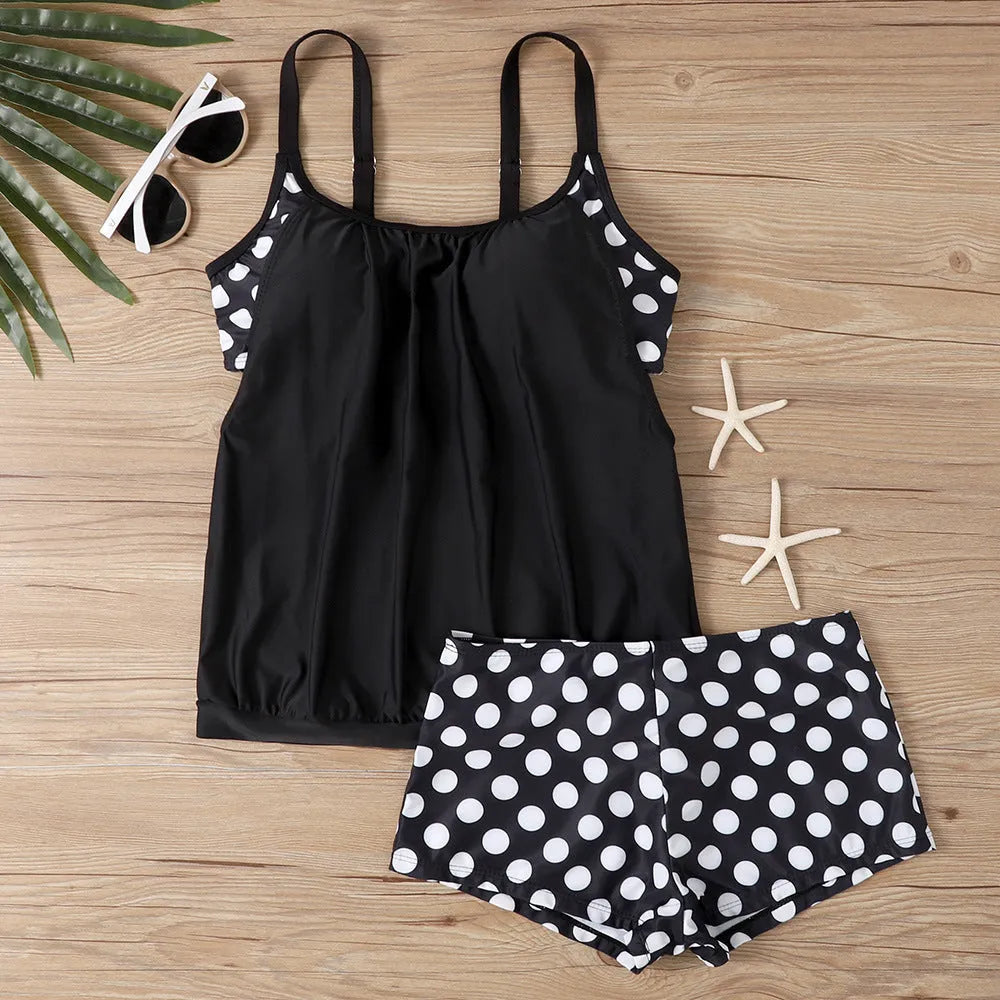 Women's black polka dot high-waist swimsuit with conservative briefs style on a mannequin.