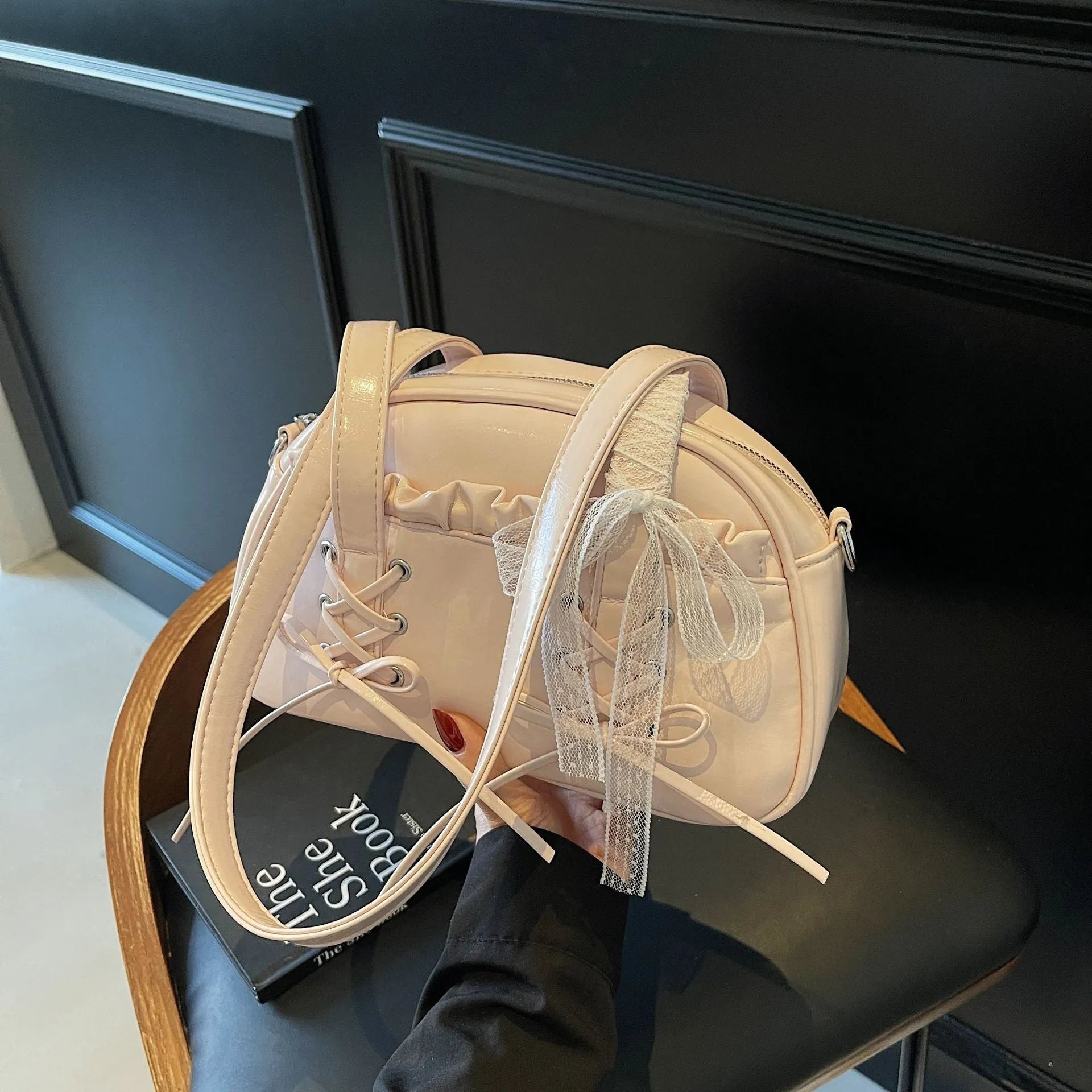 Milky white women's PU leather shoulder bag with a removable bandage bow and visible sewing thread detailing