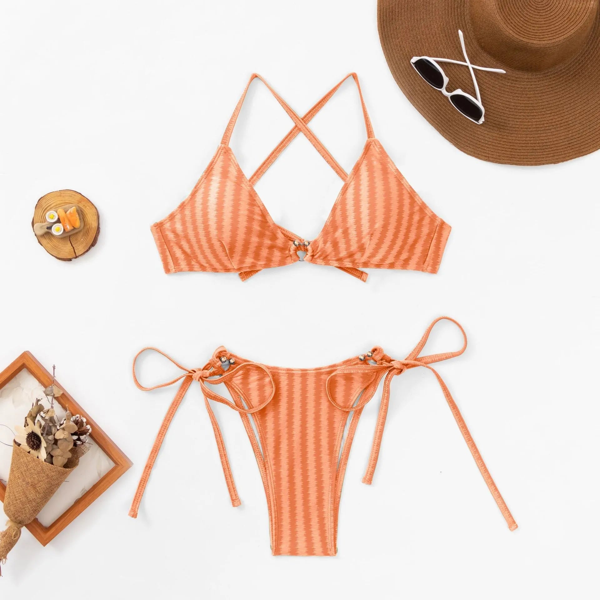 Red jacquard lace-up bikini top and briefs laid flat, showing backless design and quick-dry fabric.