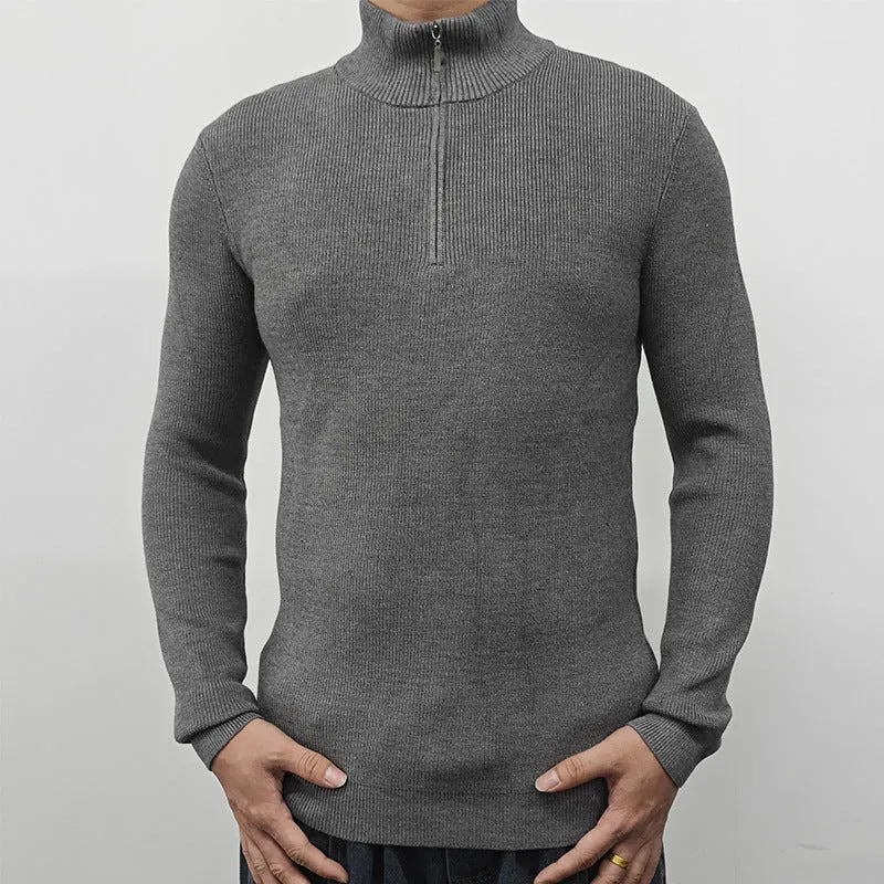 Man wearing a gray zip-front half-turtleneck long sleeve cotton blend sweater.