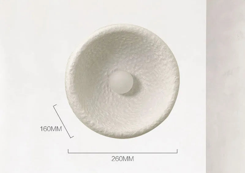 Japanese-style simple silent wall lamp with resin shade in three diameter sizes on white wall