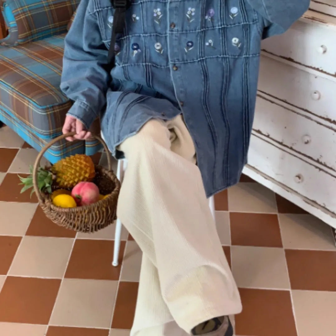 Vintage washed blue denim shirt with small floral print and pleated detailing on long sleeves