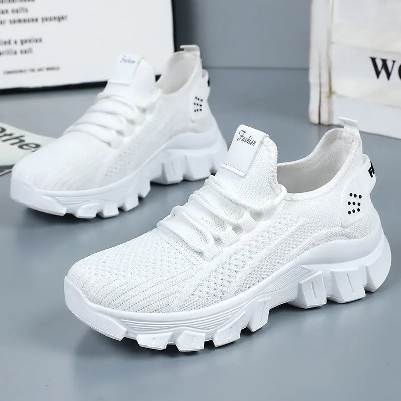 Women's white Flyknit sneakers with a thick PVC sole and front lace-up on a plain background.