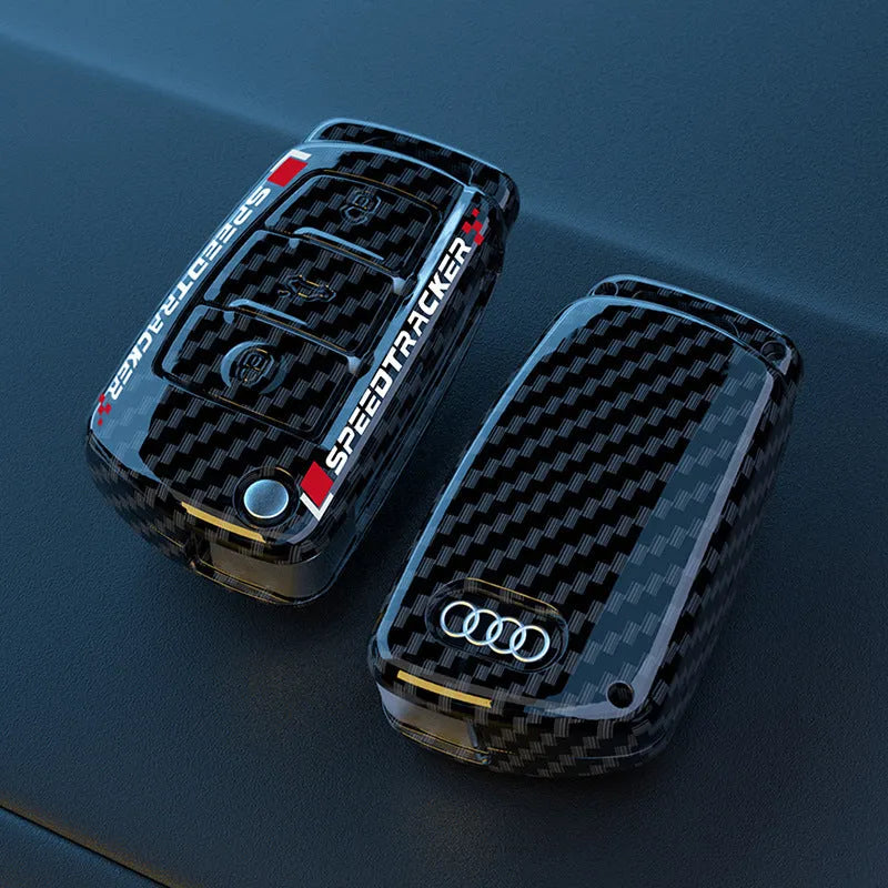 White and carbon coloured car key holders with a carbon fibre texture and mirror surface.