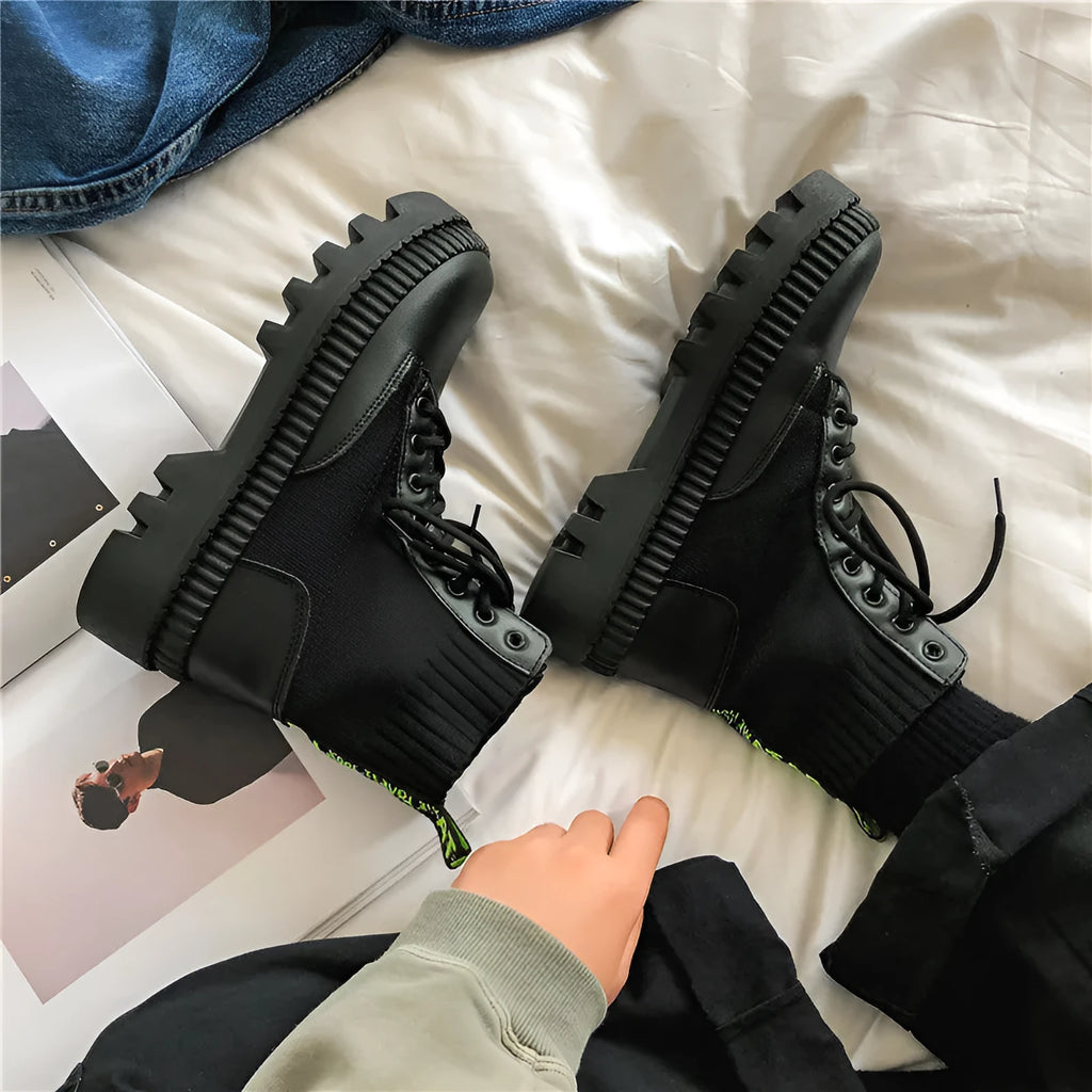 Men's black platform ankle boots with 8-eye lacing and a side zipper on a rubber sole.