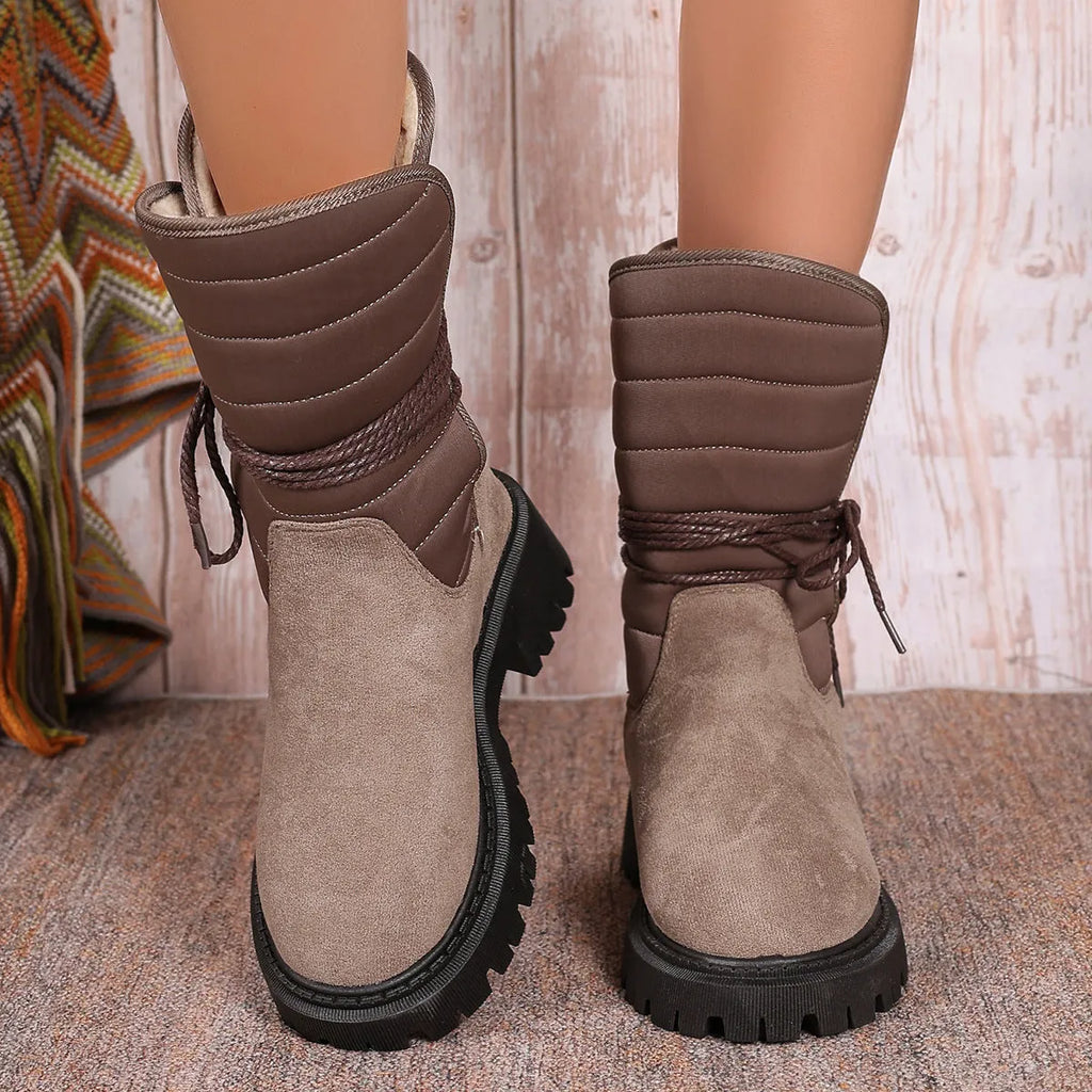 Women's black suede snow boots with chunky heel, lace-up design, and fleece lining