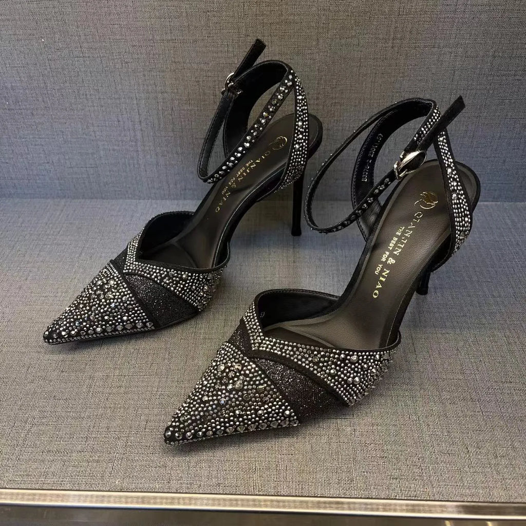 Women's silver high heels with hollow cut-out design and red stiletto heel sole.