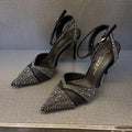 Women's silver high heels with hollow cut-out design and red stiletto heel sole.