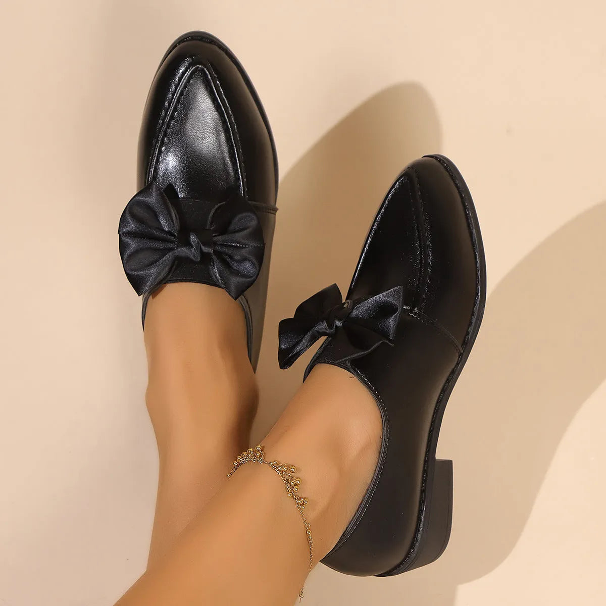 Women's British-style leather shoes with decorative bow detailing on pointed toe