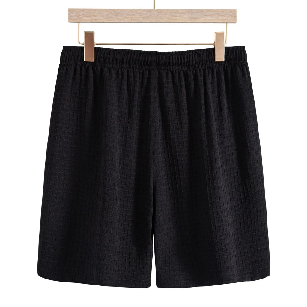 Men's black cotton blend short sleeve shirt and matching shorts set displayed together