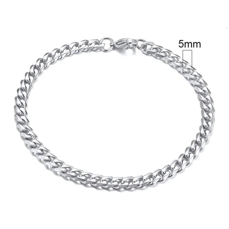 Six-sided geometric Cuban link metal bracelet in gold, black, and steel colour finishes.