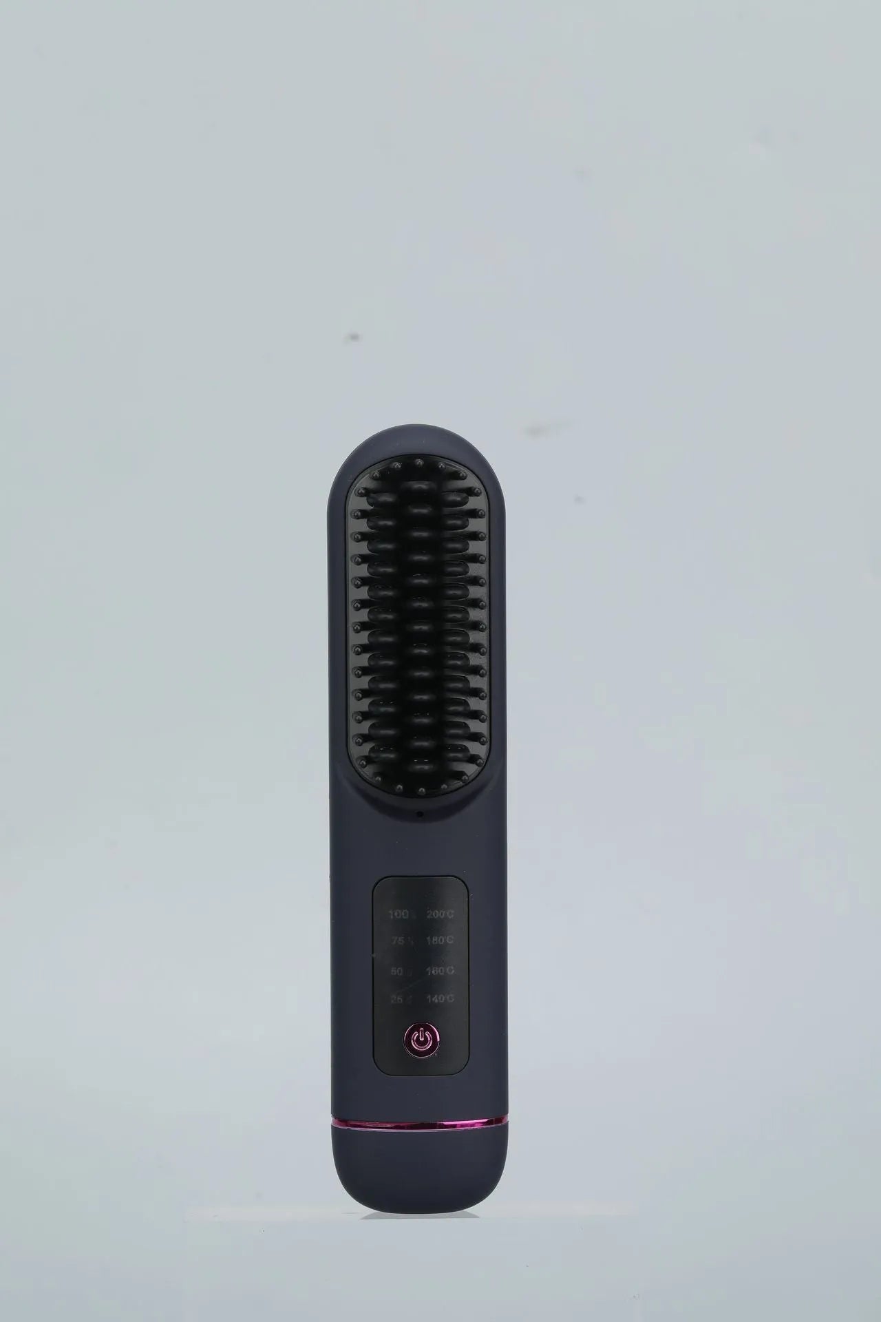 A white portable negative ion hair comb with USB charging port on a dark surface.