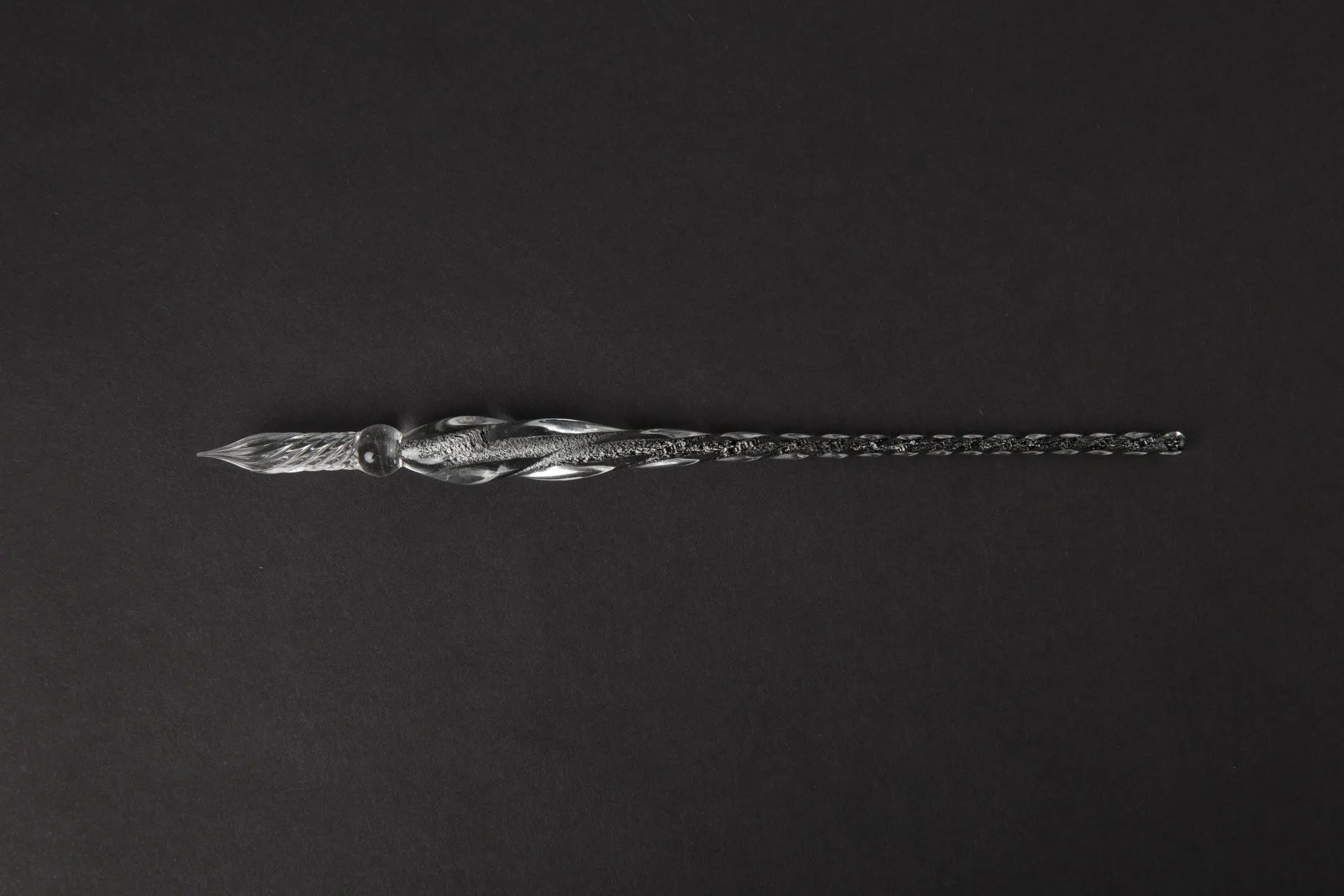 Transparent glass art pen with coloured ink dipped design in a gift box.