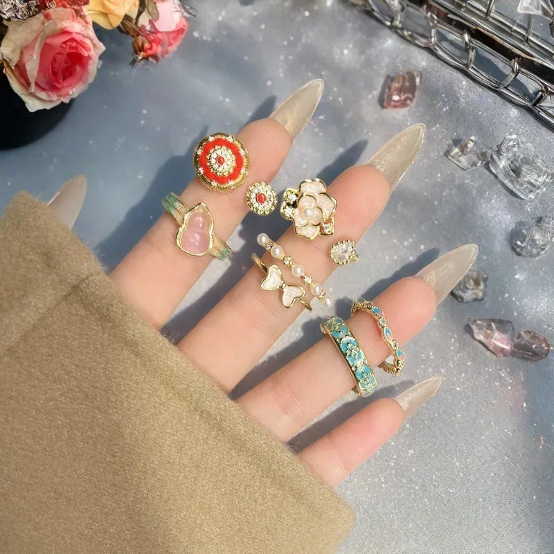 Adjustable copper vintage gourd ring with inlaid zircon stones showing floral and bow design elements