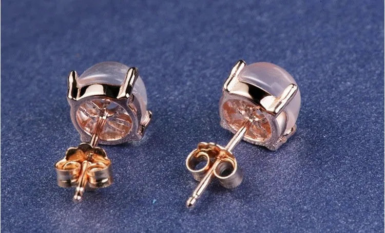 Rose gold drop shape stud earrings with synthetic ross quartz crystal inlay.