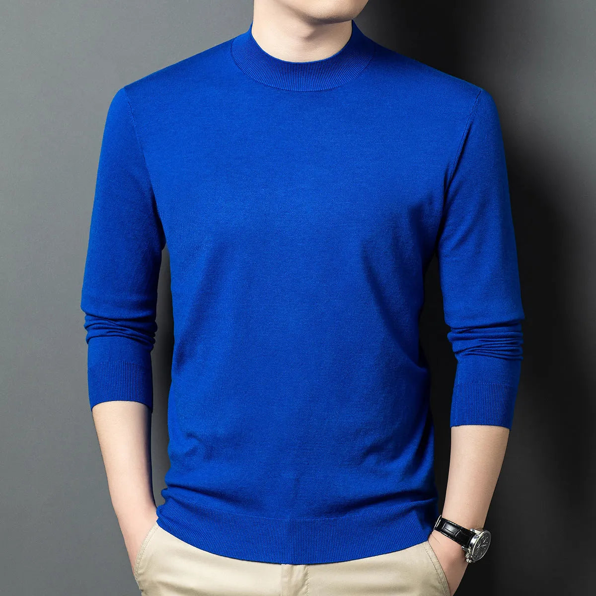 Man wearing a round neck long sleeve wool blend pullover sweater in a neutral colour.