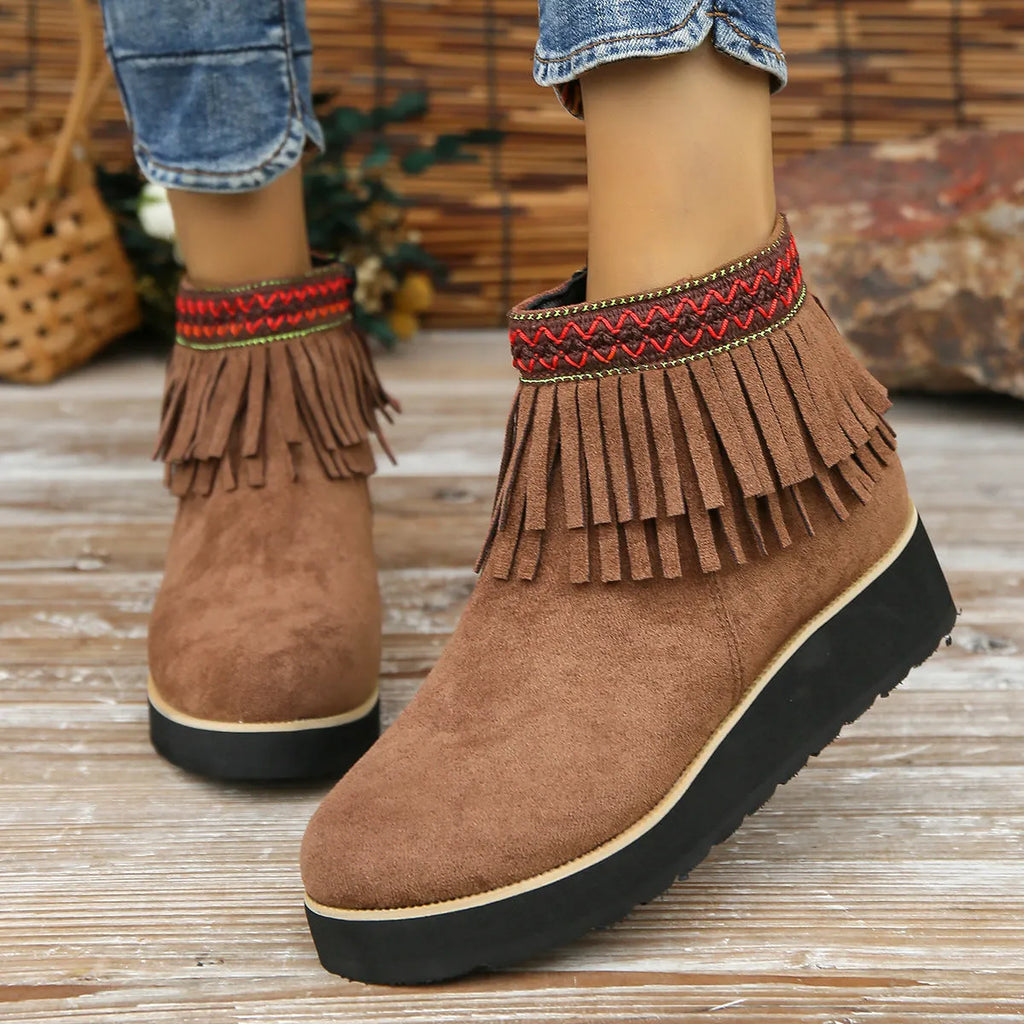 Women's dark brown suede wedge ankle boots with a side zipper and decorative tassel.