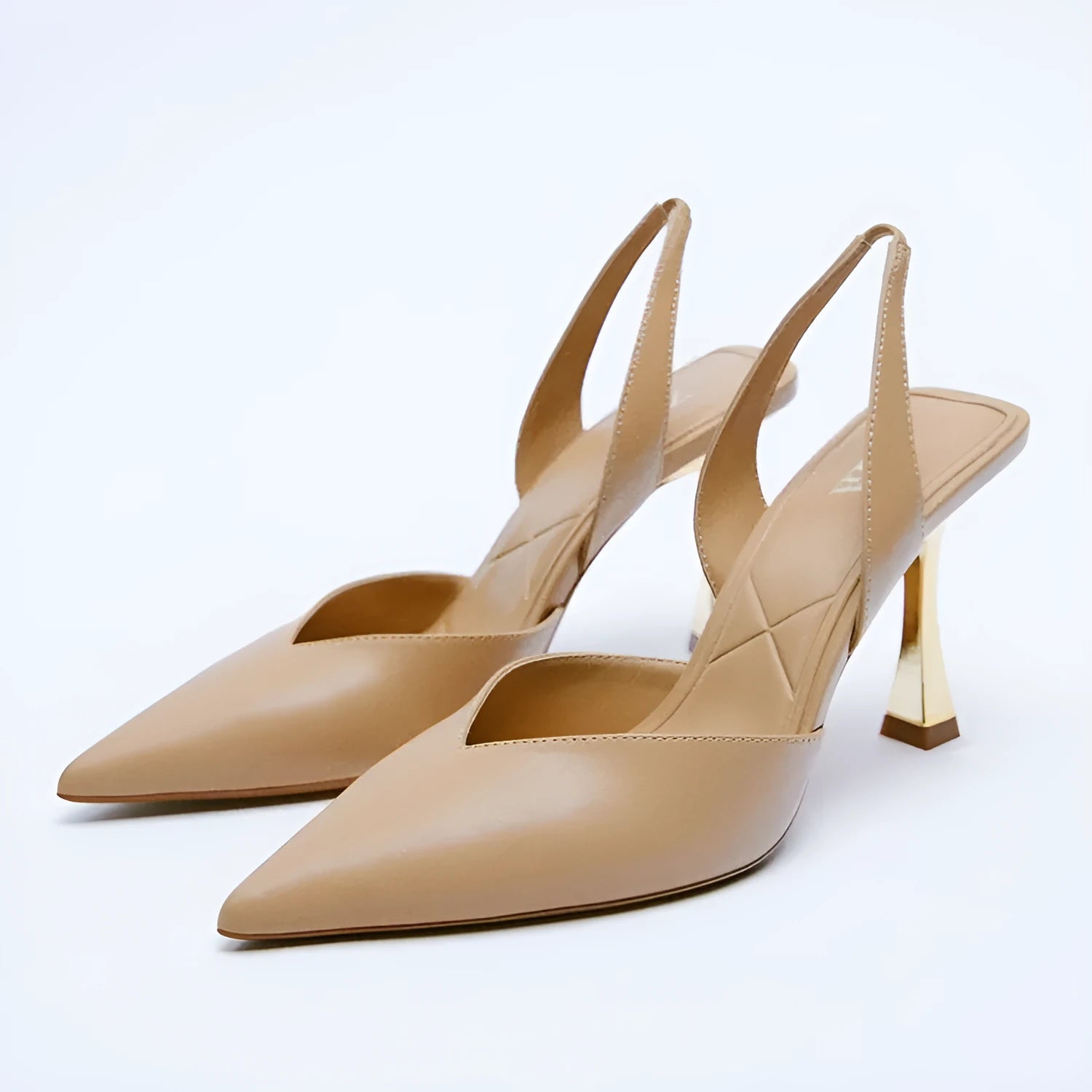 Apricot and black patent leather pointed high heels with a shallow-cut vamp, shown from the side.