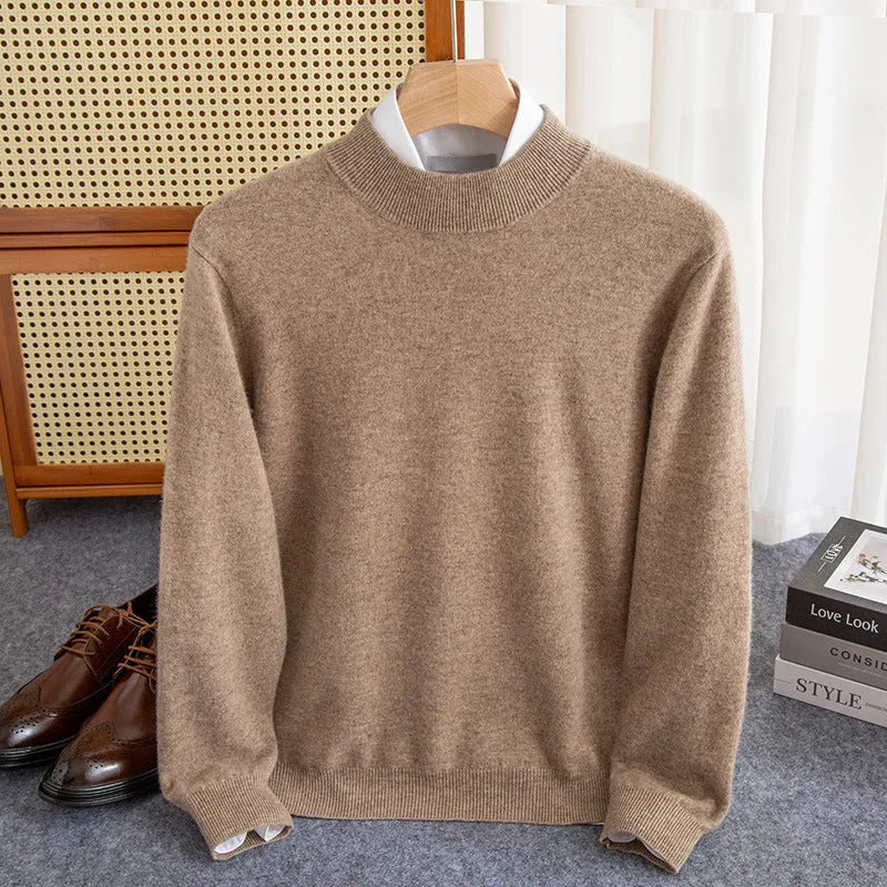 Man wearing a loose-fit, chunky knit wool sweater with a half-turtleneck collar in a neutral colour.