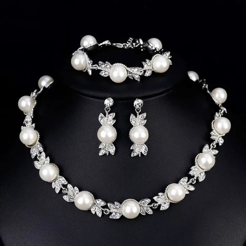 Three-piece jewellery set with rhinestone and pearl necklace, earrings, and bracelet in silver finish
