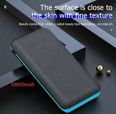 Black portable power bank with solar panel, wireless charging surface, and three USB output ports