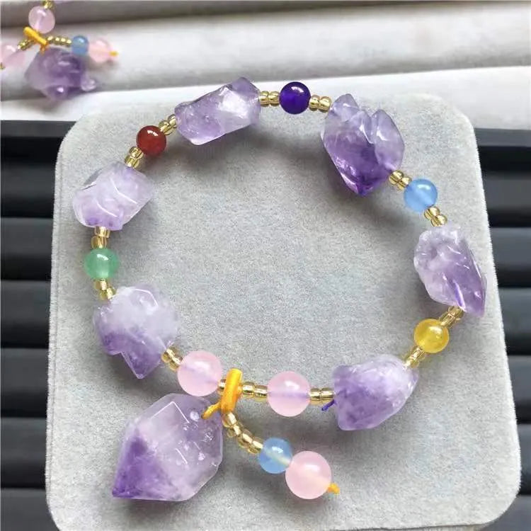 Women's natural amethyst shaped bead bracelet with a fu character charm.