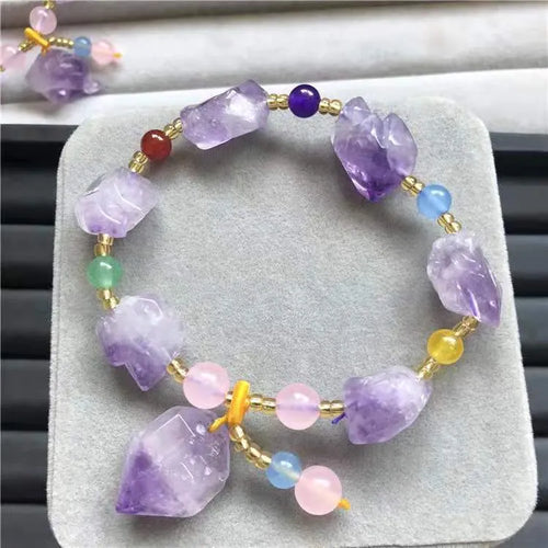 Women's natural amethyst shaped bead bracelet with a fu character charm.
