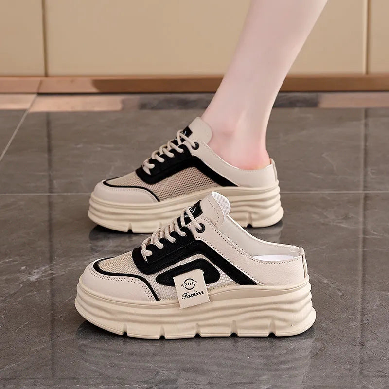 Women's black mesh half slippers with round toe and rubber sole, shown from the side.