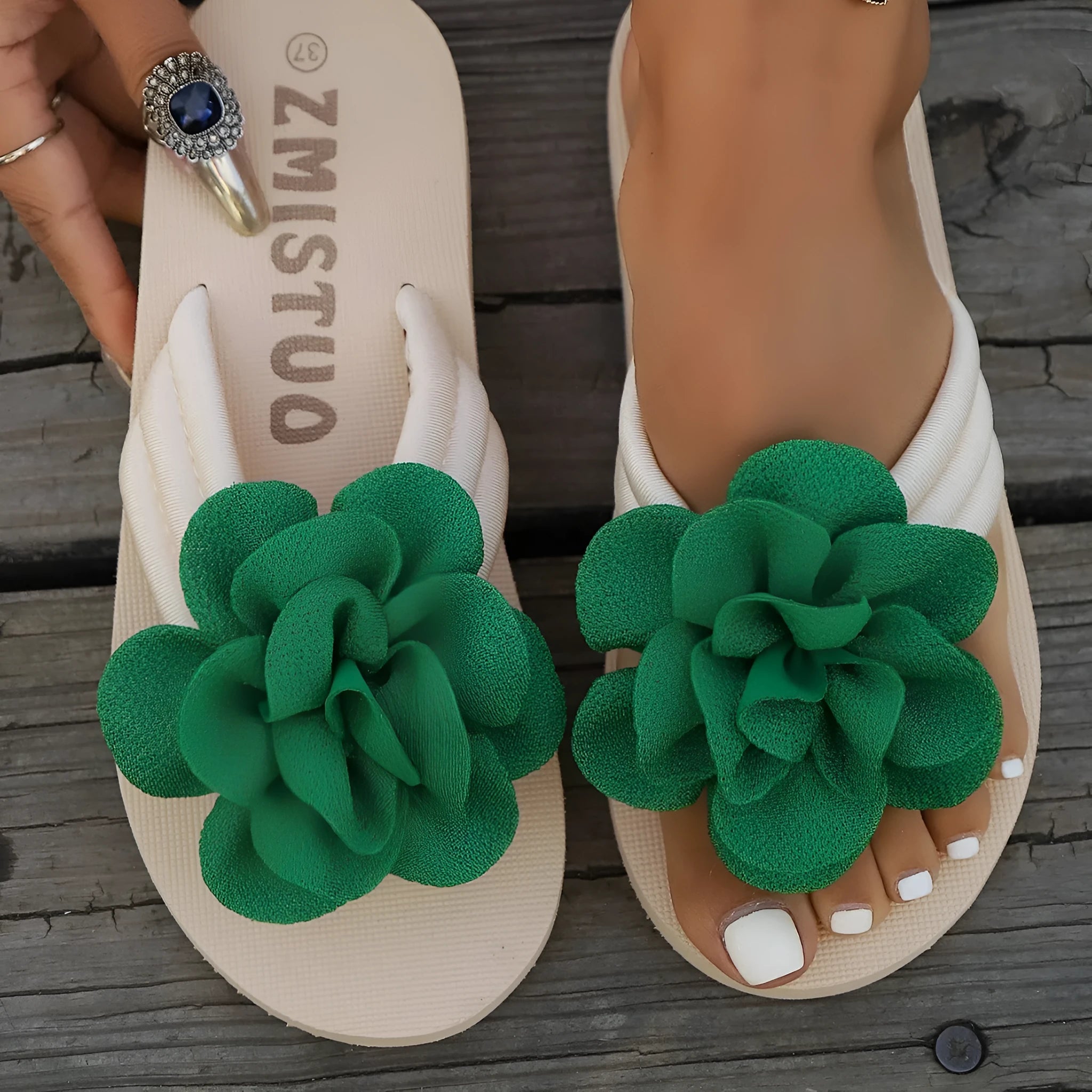 Plus size floral slipper in solid colour with round toe and flip flop style.