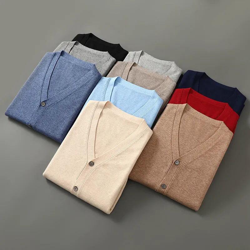Man wearing a loose V-neck cardigan coat in Andy Velvet fabric, showing the long sleeves and available colour options.