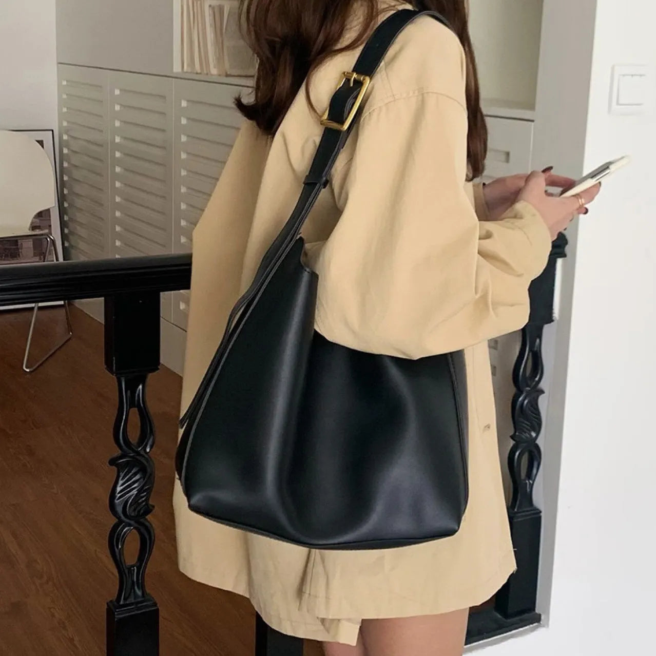 Women's soft PU leather shoulder bag with decorative threads measuring 28x32x12cm in black and brown colour options