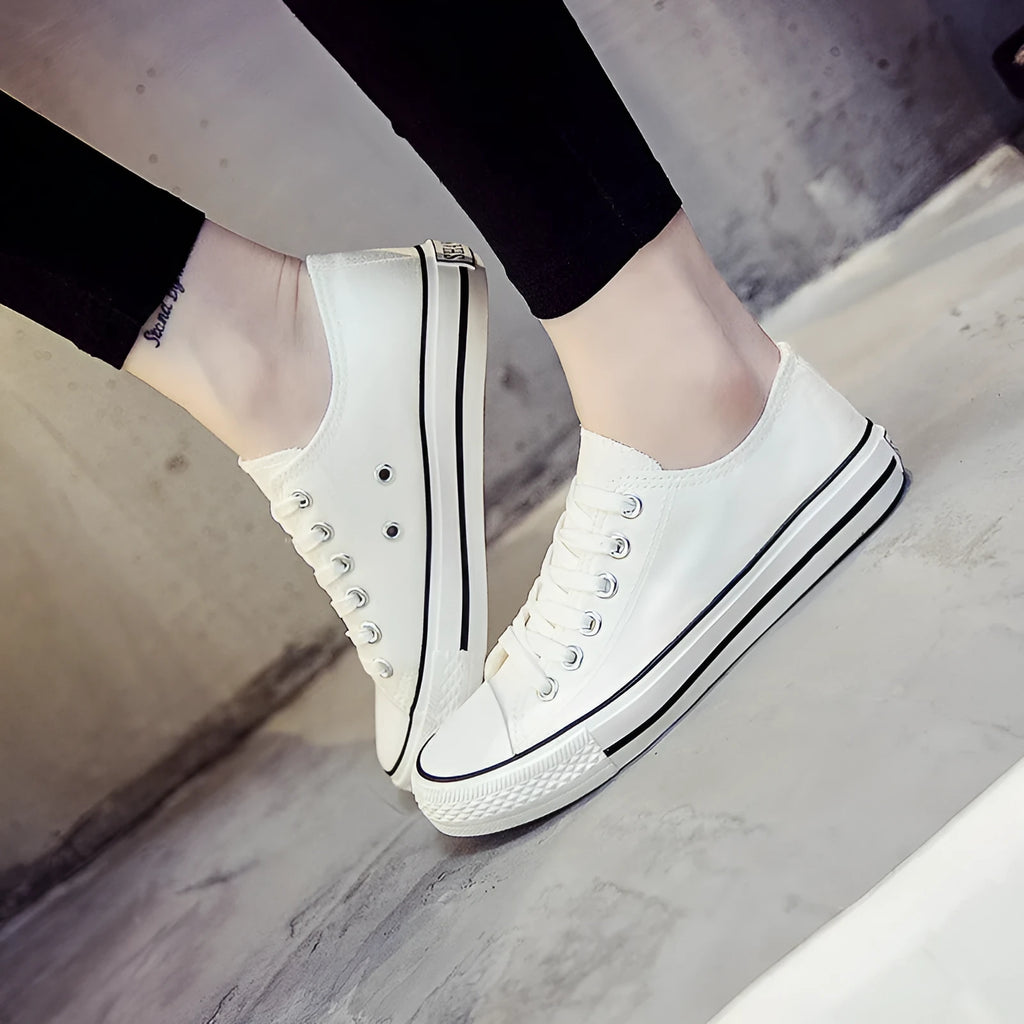 Women's solid colour casual canvas shoes in lace-up style on a white background.