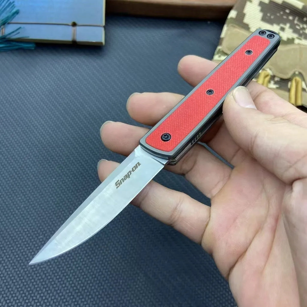 Closed and open views of a folding fruit knife with a coloured handle and stainless steel blade.