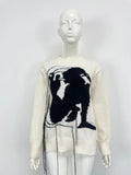 Grey alpaca wool women's sweater with abstract pattern and tassel detail on sleeve.