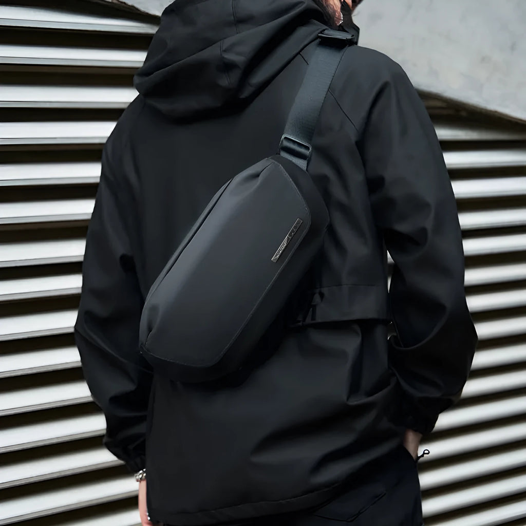Black Oxford cloth men's messenger bag with a one-shoulder riding strap.