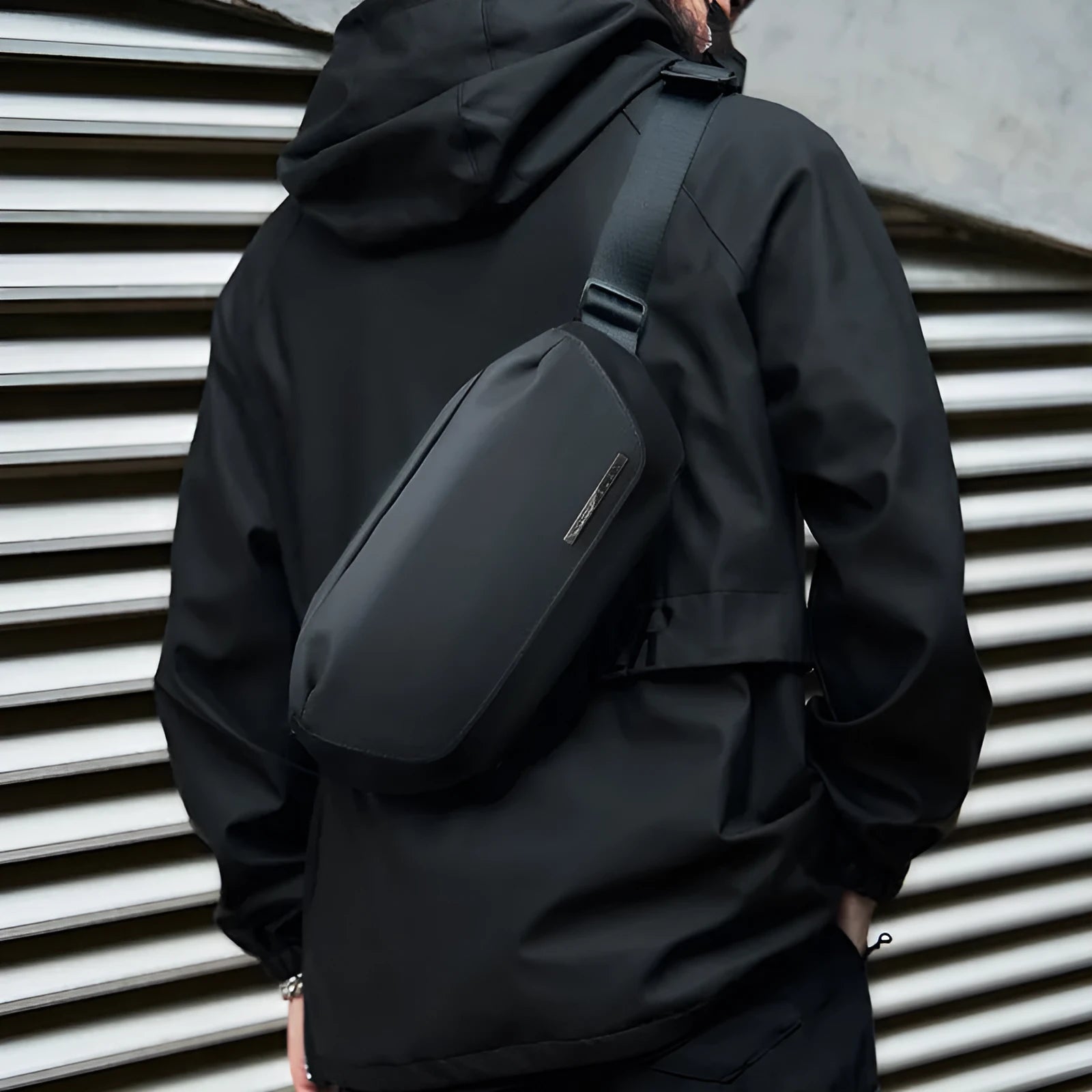 Black Oxford cloth men's messenger bag with a one-shoulder riding strap.