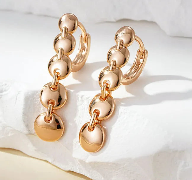 Gold coloured woven copper circle drop earrings with retro design