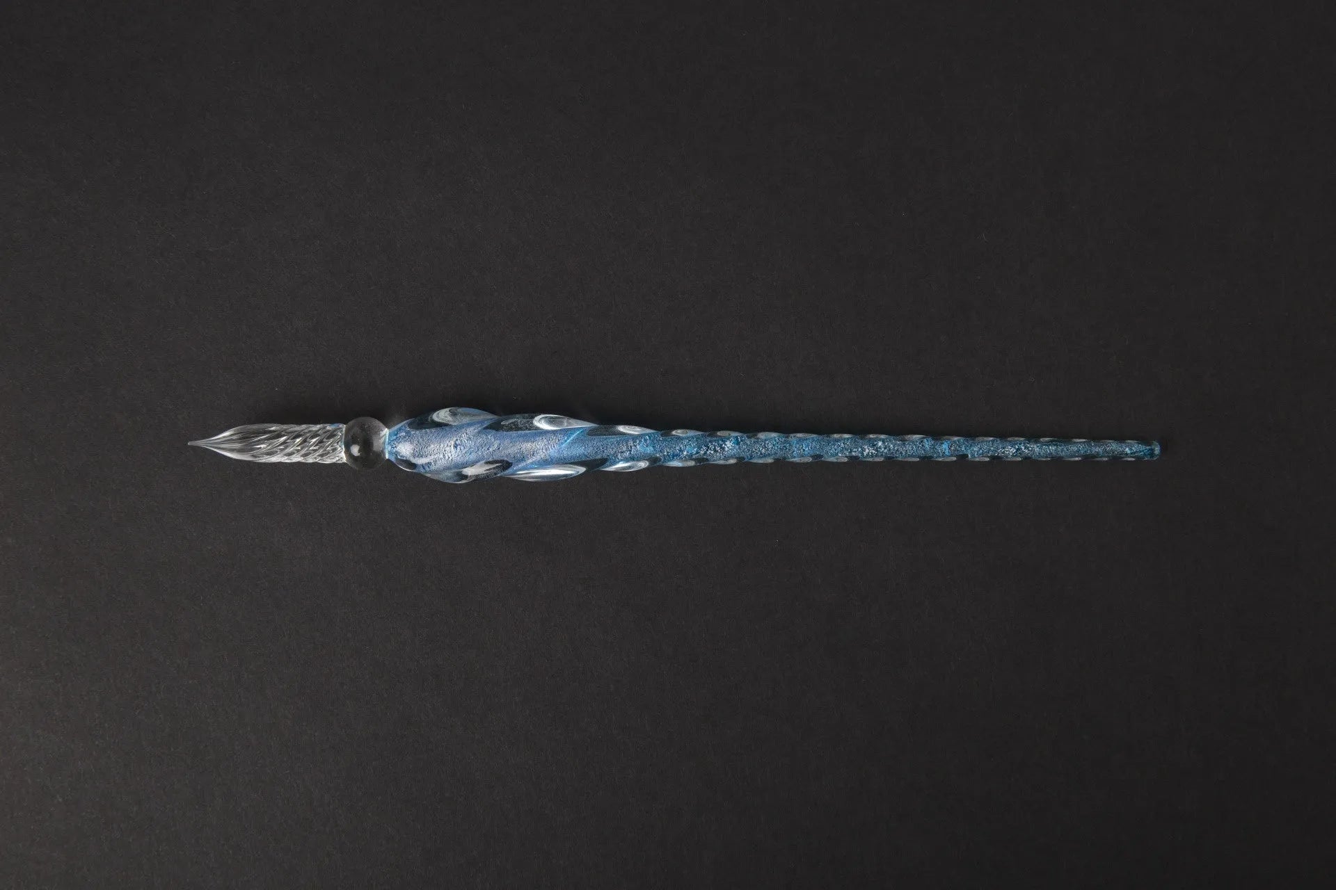 Transparent glass art pen with coloured ink dipped design in a gift box.